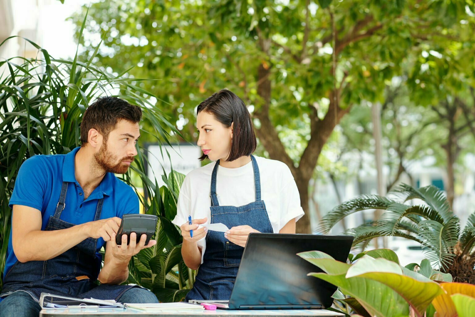 a man and a woman looking at a tablet