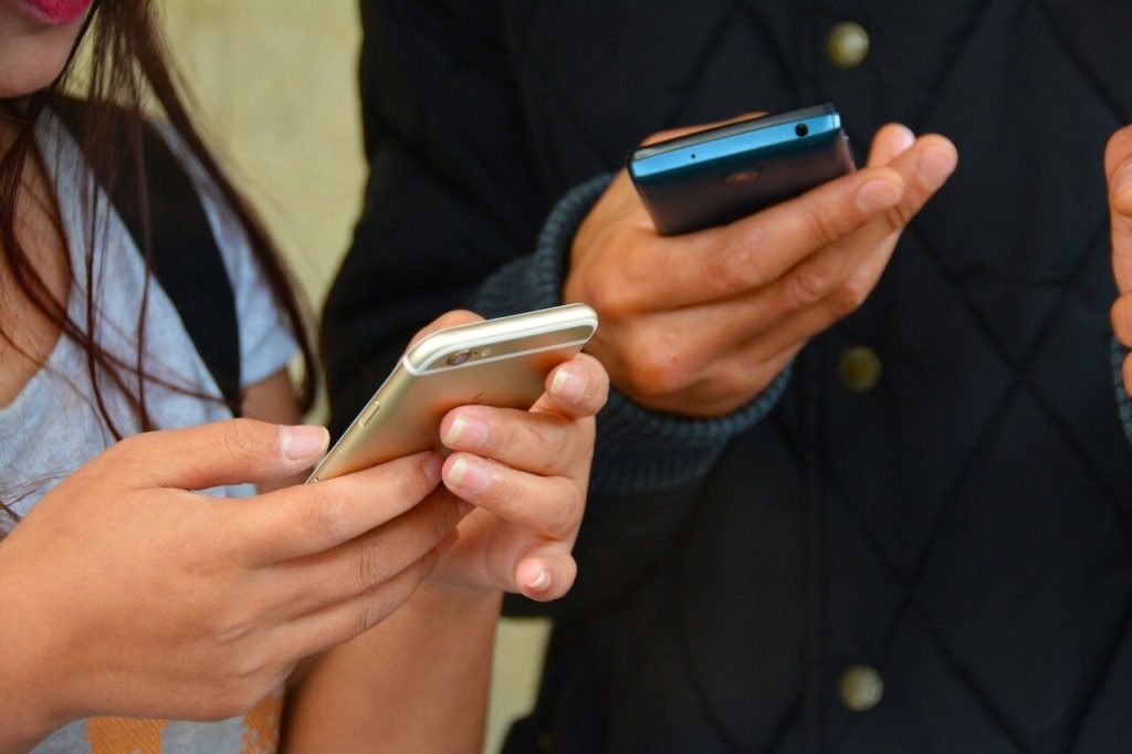 a group of people holding cell phones