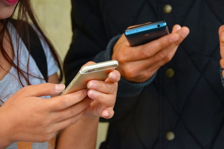 a group of people holding cell phones