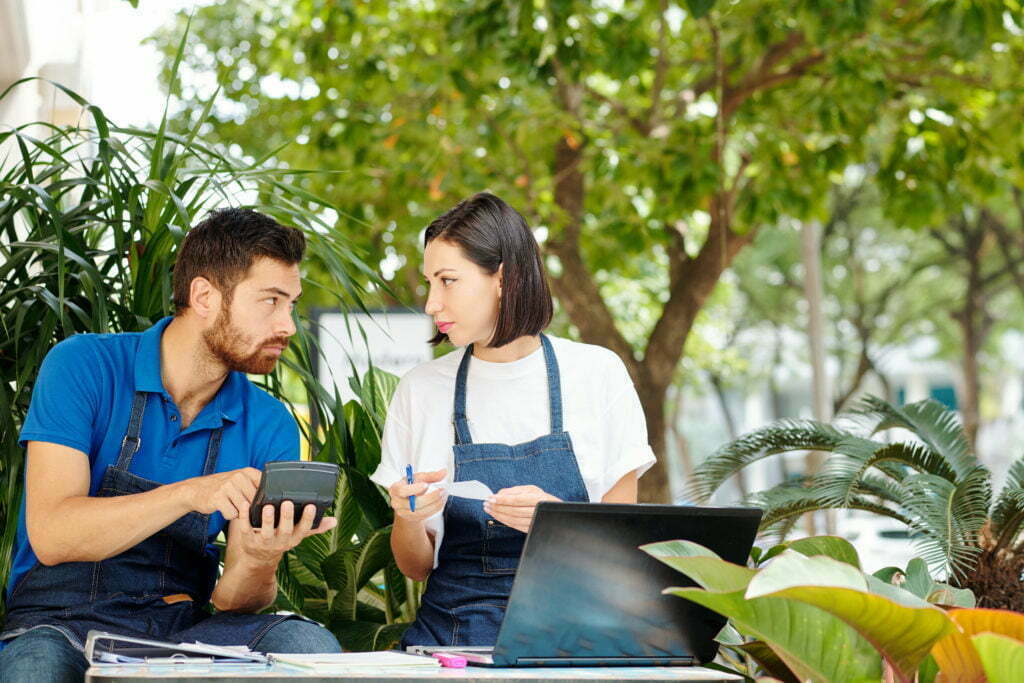 a man and a woman looking at a tablet