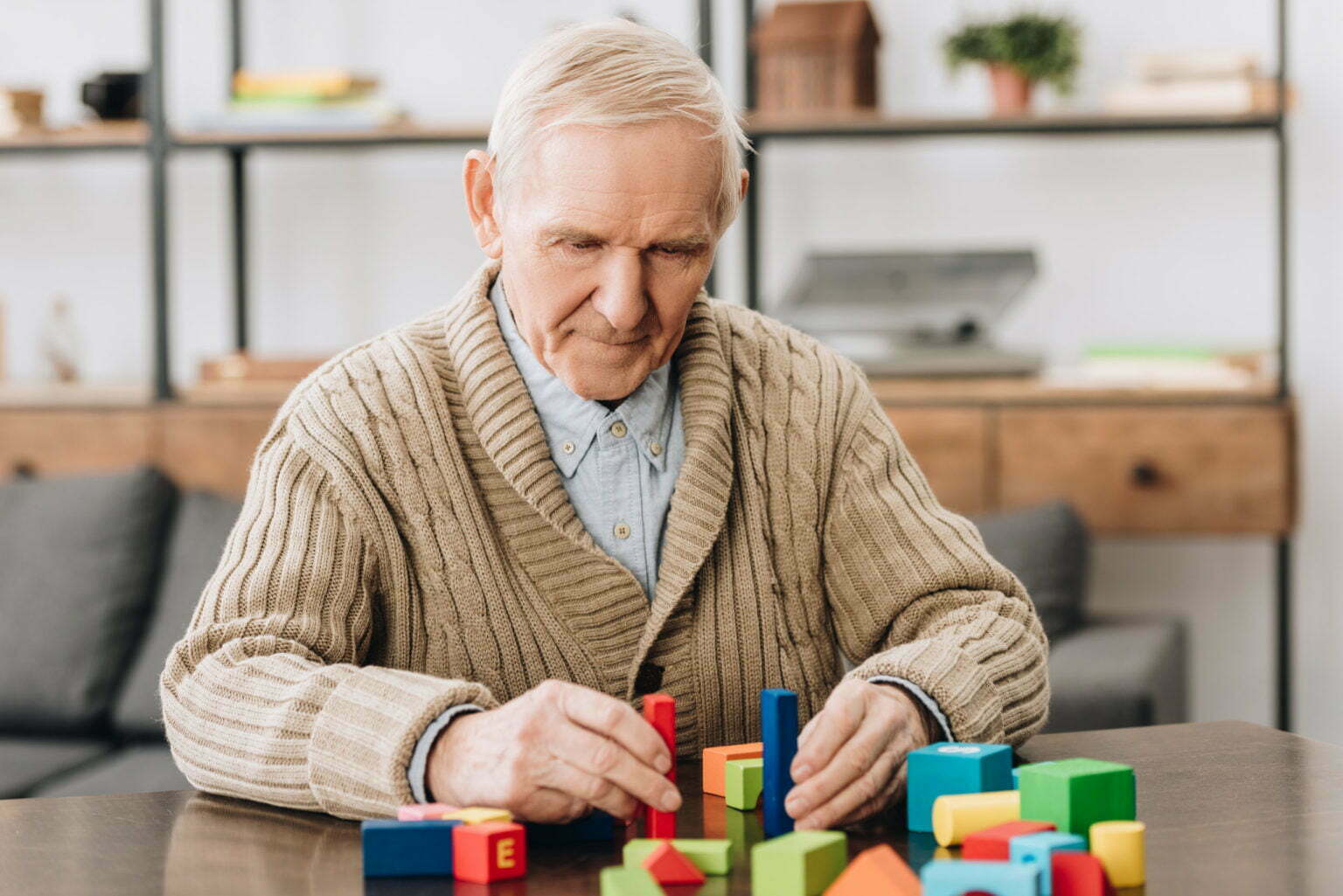 OLDER MAN PLAYING WITH BLOCKS